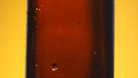 Pull-Focus-Shot-Of-Condensation-Droplets-Running-Down-Side-Of-Bottle-Of-Cold-Beer-Or-Soft-Drink-With-Copy-Space